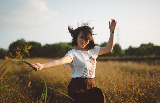 Happy young woman in field