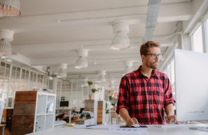 Man in business office at a standing desk