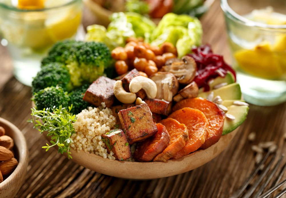 Healthy plant-based dinner with vegetables, quinoa, cashews and tofu. 