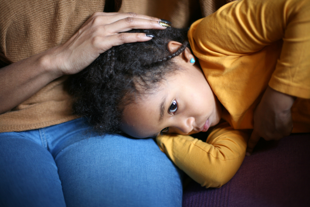 Mother comforting sick child