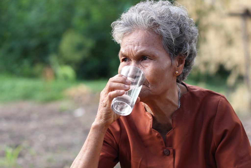 Senior woman drinking water