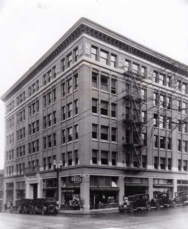 An historic black and white photo of the Mayer Building at SW 12th and Morrison.