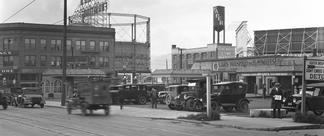 A black and white photo of a busy street in historic Portland, Oregon.