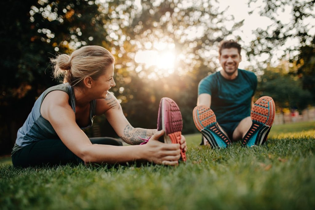 Young man and woman exercising outdoors