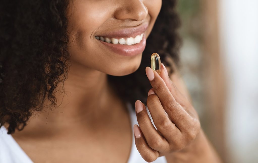 Woman taking a supplement